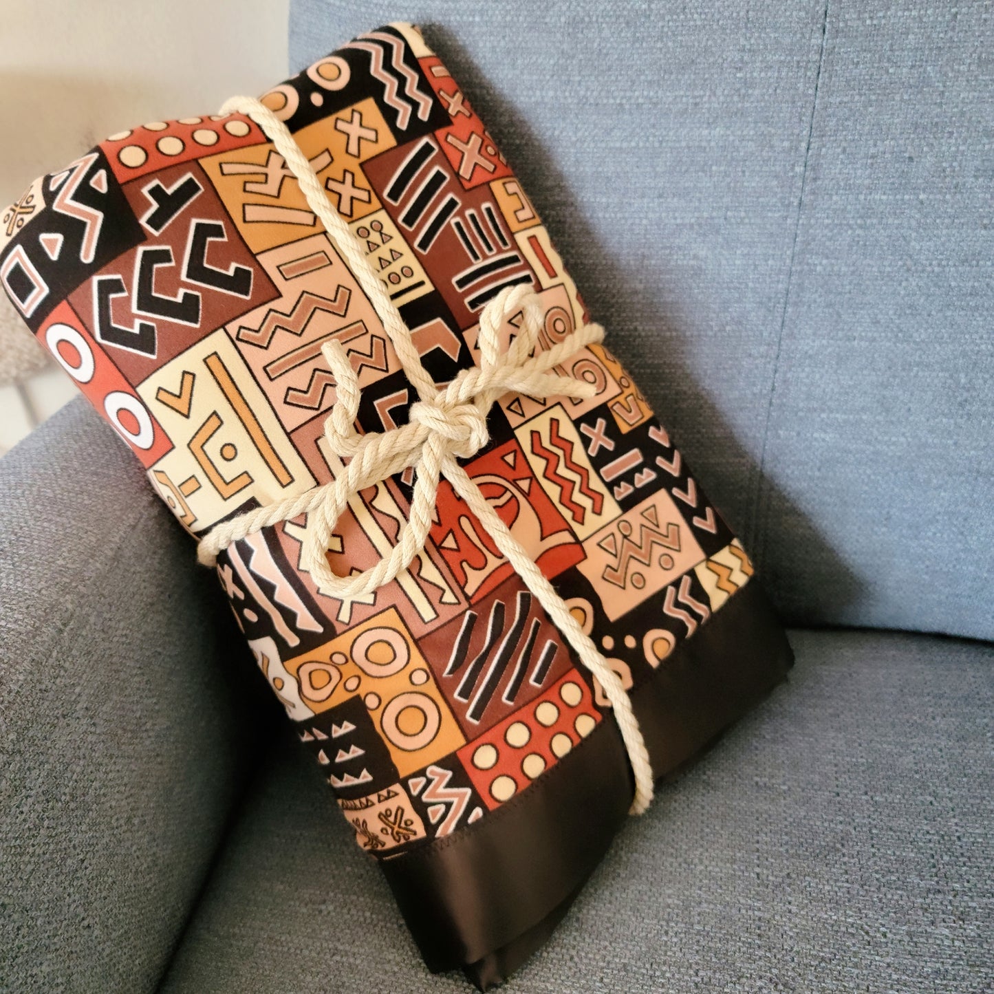 A vibrant close-up of a colorful oversized throw featuring intricate geometric patterns.