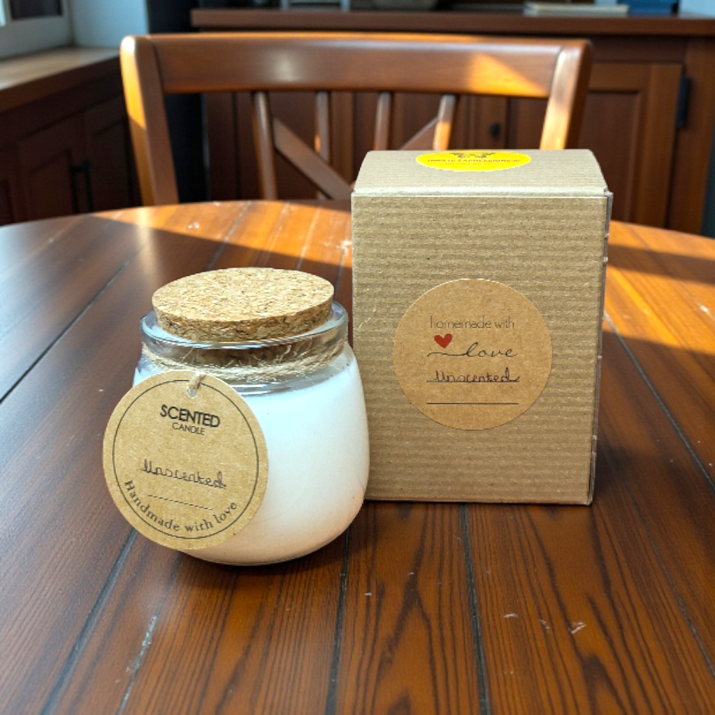 Scented candle with cork lid and packaging box on a wooden table