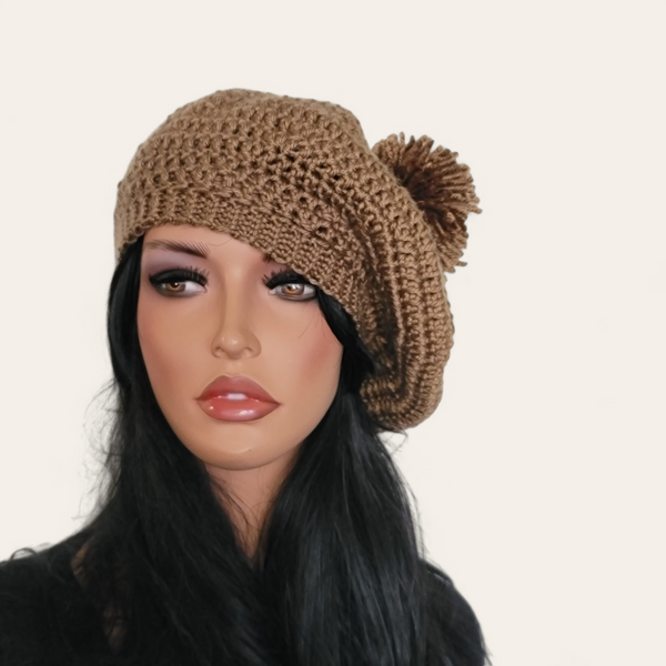 Walnut brown crocheted beret with pom-pom on mannequin.