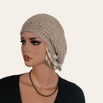 Tan crocheted beret without pom-pom on mannequin.