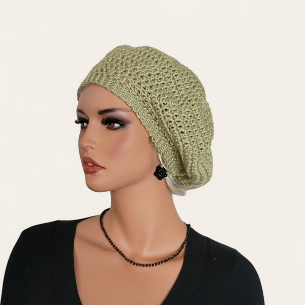 Celery green crocheted beret without pom-pom on mannequin.