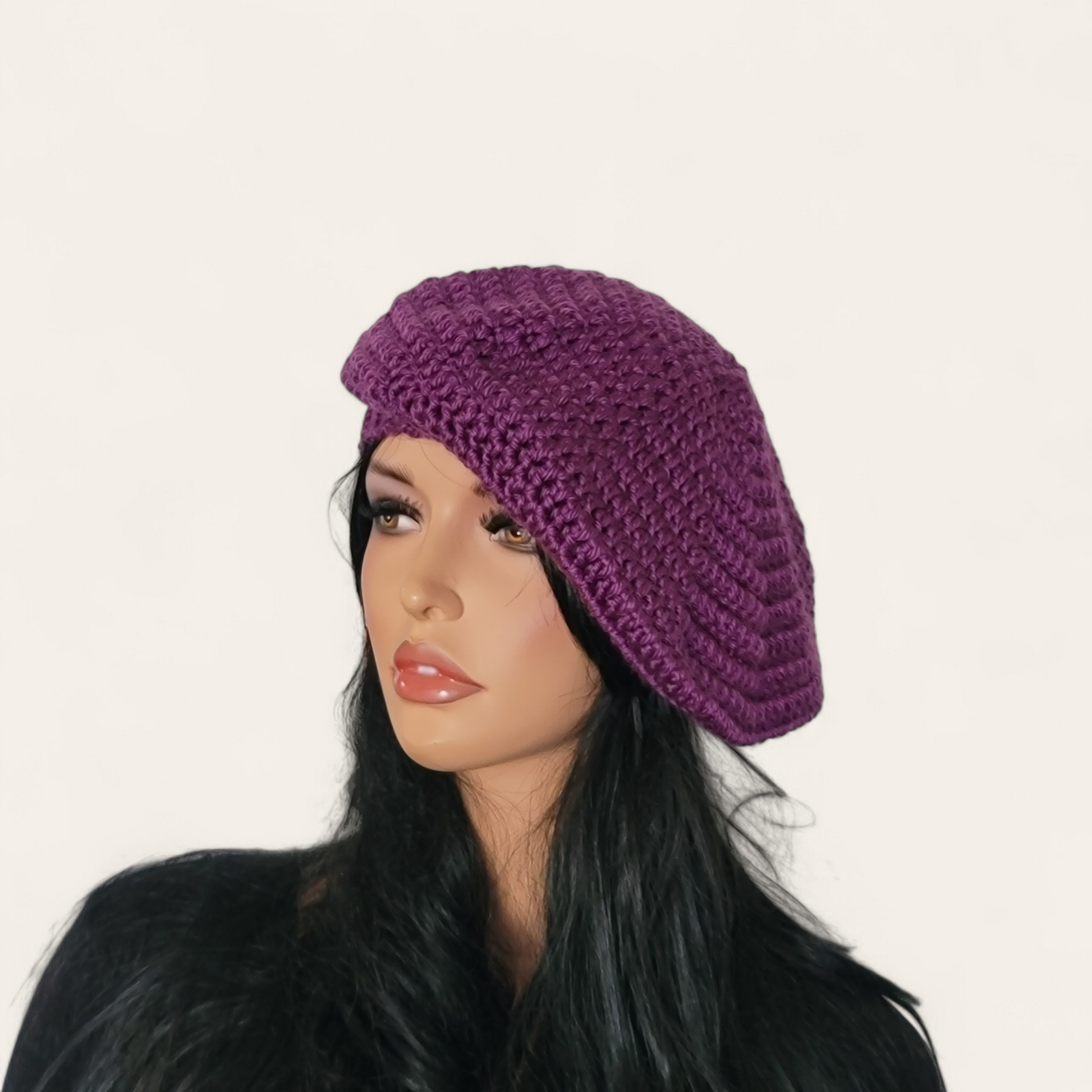 Purple crocheted beret without pom-pom on mannequin