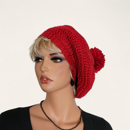 Red crocheted beret with pom-pom on mannequin