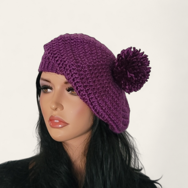 Purple crocheted beret with pom-pom on mannequin