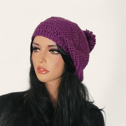 Purple crocheted beret with pom-pom on mannequin